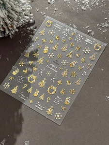 Detail of Christmas nail stickers with 3D gold embossed deer and tree designs