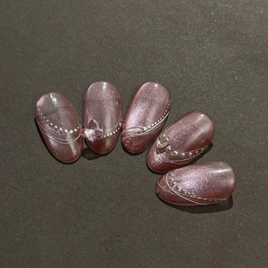 Purple cat eye press-on nails with 3D butterfly and heart accents in oval shape