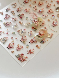 Detailed view of 3D embossed Christmas nail stickers with Santa and snowman patterns