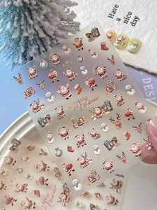 Detail of 3D embossed Christmas nail stickers with Santa and Merry Christmas text
