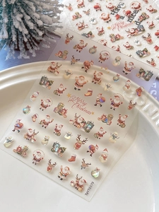 Detail view of 3D Christmas nail art stickers featuring Santa, reindeer and snowflakes