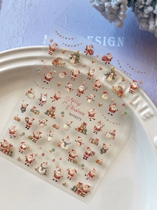 Macro shot of 3D embossed Christmas nail stickers with Santa, snowman, and tree patterns