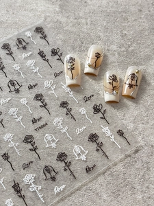 Detailed relief rose nail stickers with floral patterns and artistic lettering for manicures