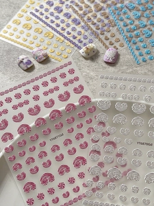 Detailed 3D embossed nail stickers featuring colorful spiral patterns and metallic textures