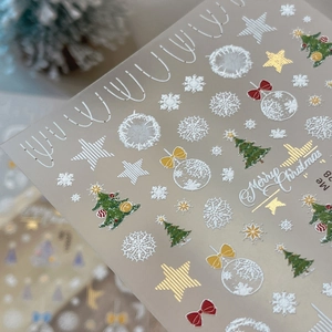 Embossed Christmas nail stickers with gold foil trees, snowflakes and red star patterns