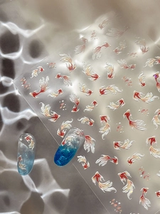 Macro detail of Chinese koi fish nail stickers with shimmering water bubble patterns