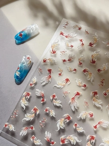 Detail of 5D koi fish nail stickers with embossed red and white carp patterns