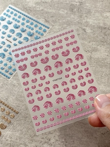 Macro view of 3D embossed jelly cream nail stickers with wave and dot textures