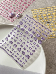 Macro detail of 3D embossed jelly cream nail stickers in purple, pink and gold styles