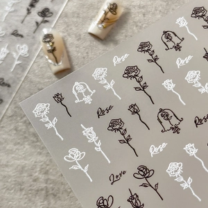 Embossed rose nail art stickers with black and white floral patterns and letters
