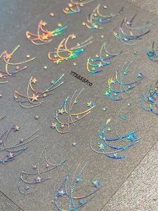 Macro shot of silver holographic star nail stickers with laser rainbow glitter effect