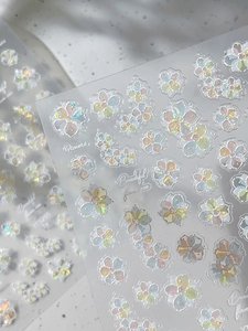 Macro shot of 3D iridescent floral nail stickers with pearlescent laser finish on YT5295
