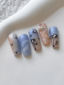 Detailed close-up of summer beach nail art with 3D starfish and palm tree relief