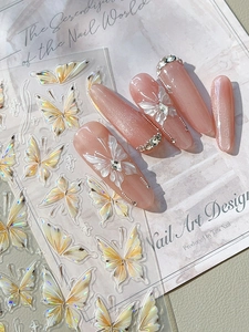 Detail of holographic butterfly nail stickers with pink cat-eye press-on nails