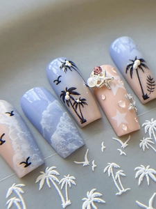 Detail of luxury ocean nails featuring 3D embossed palm trees, starfish and pearls