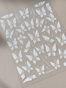 Macro view of Aurora laser butterfly nail stickers on textured grey background YT5438Tm