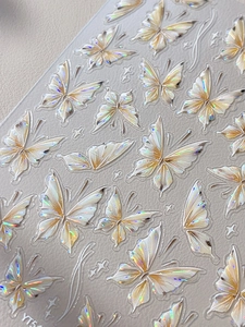 Macro shot of 3D iridescent laser butterfly nail art stickers with aurora holographic effect