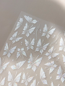 Close-up of 3D embossed holographic butterfly nail art stickers with laser finish
