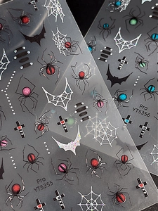 Detail of spider and web nail stickers with glitter texture and holographic effects