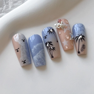 Nautical theme press-on nails with blue gradient, palm trees, and 3D seashell charms