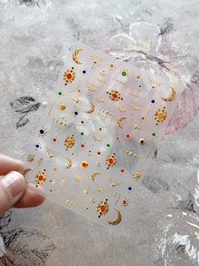 Macro detail of YT-4263 bohemian gold embossed nail art stickers with moon and sun patterns
