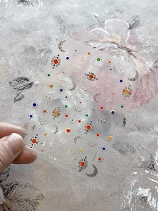 Detail of YT4264 gold foil nail art stickers with moon, sun, and mandala gem patterns