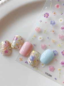 Detailed view of 3D embossed floral nail stickers featuring mini daisies and cherry blossoms