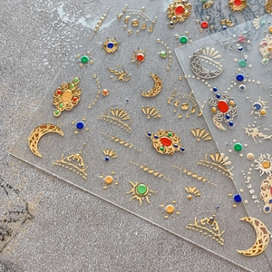 Elegant gold foil moon and star nail art stickers with vintage bohemian celestial patterns