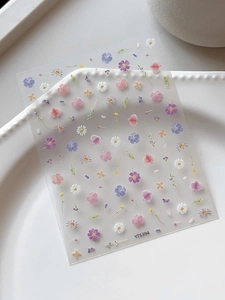 Macro view of YT5394 embossed floral nail art stickers with daisies and cherry blossoms
