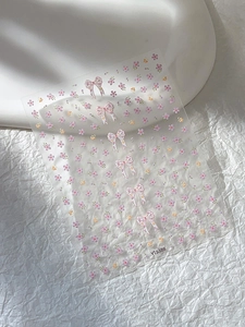 Detail shot of YT5388 nail art stickers featuring pink bows and floral patterns