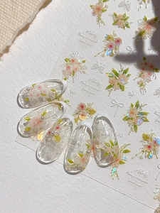 Detailed relief flower nail stickers with butterfly and pearl accents on French tips