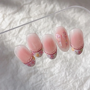 Pink gradient long oval press-on nails with floral patterns and a 3D embossed bow design