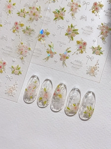 Detailed relief flower nail stickers featuring pink floral patterns and white bows