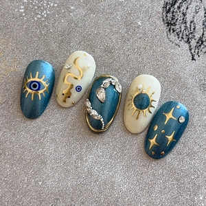 Golden eye and serpent nail art stickers with blue glitter and celestial sun pattern
