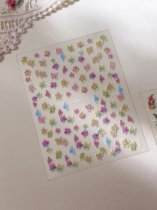 Macro shot of 3D embossed oil painting flower nail stickers in various colors