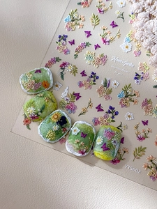 Detail of Monet Garden embossed floral nail stickers with green matte textured finish