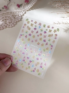 Macro shot of oil painting flower nail stickers on lace background with YT5603 details