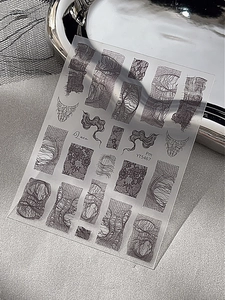 Detailed view of black lace nail art stickers with abstract lines and mesh patterns