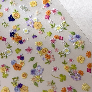 3D floral embossed nail stickers featuring colorful garden daisy and leaf designs