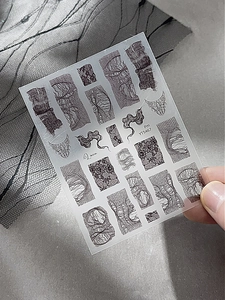 Close-up of elegant black lace nail stickers with abstract mesh and wave patterns