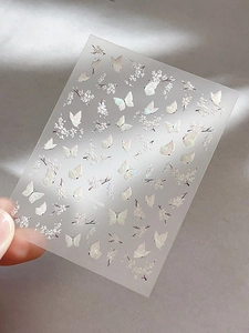 Detail of aurora shell butterfly and cherry blossom nail stickers with 3D laser effect