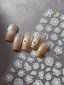 Macro view of YT4032 3D embossed white floral nail art stickers with delicate flower textures