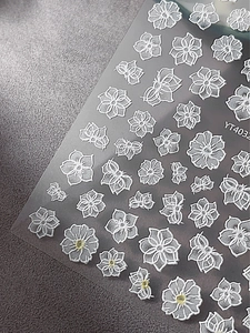 Macro shot of 3D embossed white floral nail art stickers with relief texture YT4032