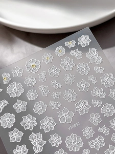 Macro detail of YT4032 embossed white floral nail stickers with textured petal designs