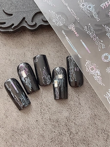 Detail of silver laser cyberpunk nail art stickers with circuit board patterns