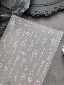Close-up of cyberpunk nail art stickers with neon circuit board patterns and metallic finish