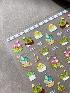 Macro shot of 3D colorful cactus and succulent nail stickers with embossed textures