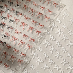 3D textured bow nail art stickers in red, white and black for creative DIY manicures