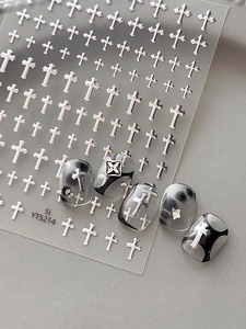Silver cross nail stickers with metallic texture shown on black and grey marbled nails