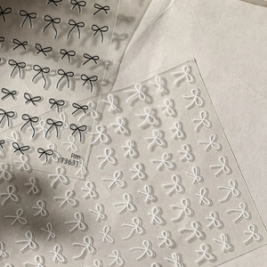 Minimalist hand-drawn bow nail stickers in black and white with transparent backing